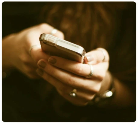 Hands looking up information on a phone